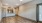 a room with a ceiling fan and a wood floor