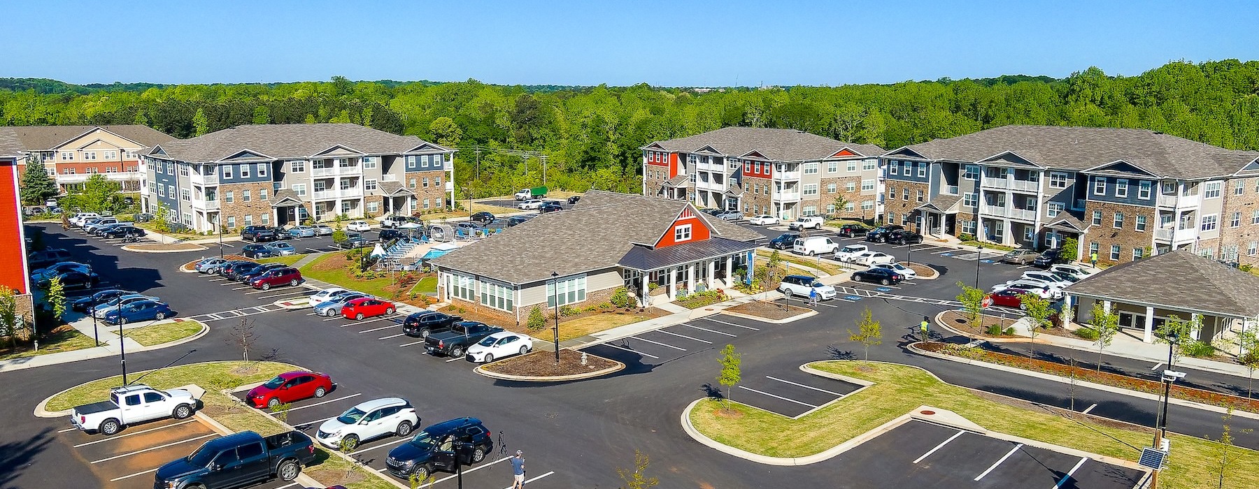 a parking lot with cars and houses