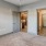 a room with a carpet and a ceiling fan