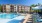 a swimming pool in front of a large building