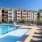 a swimming pool in front of a large building