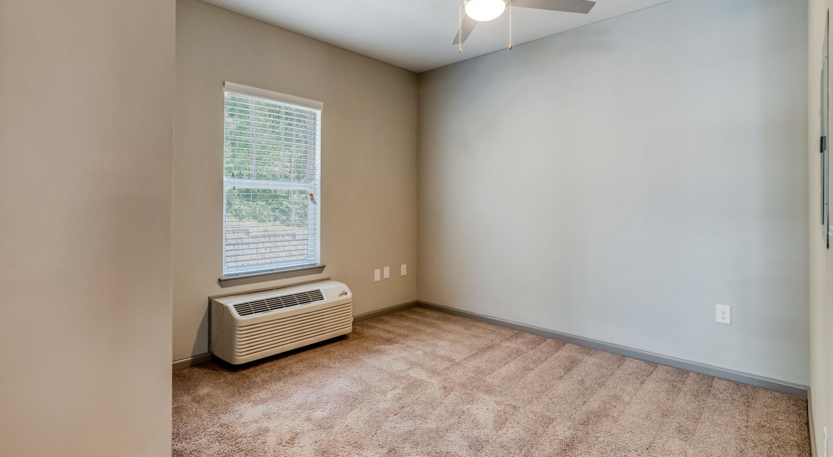 Find your perfect fit at Ascent Athens a room with a fan and a window