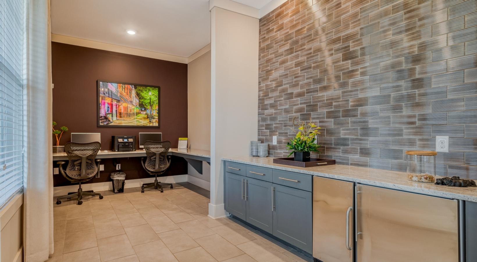 Settle into comfort at Ascent Athens a kitchen with a bar and chairs