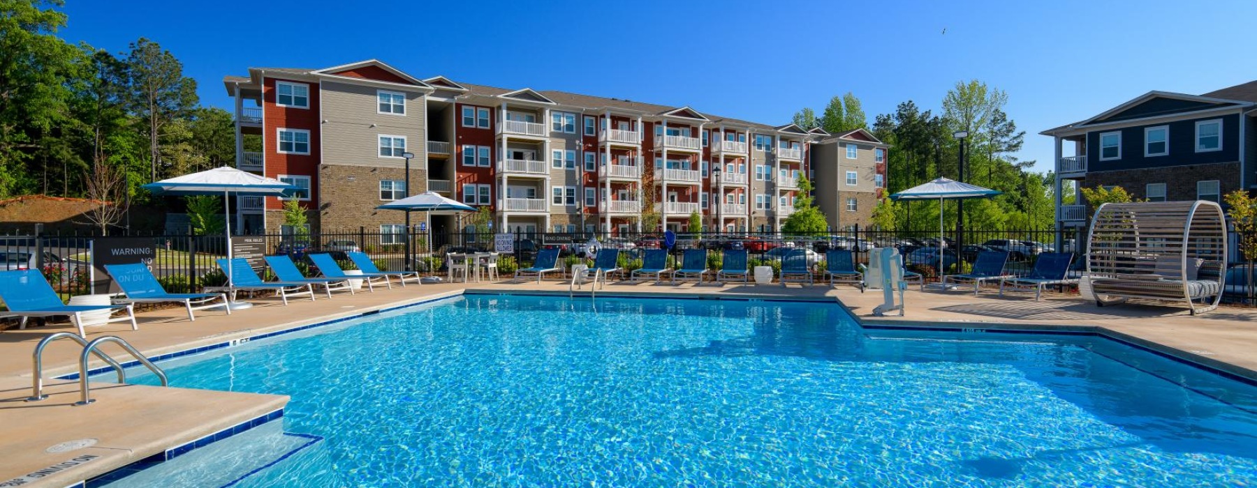 a swimming pool with a building in the background