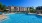 a swimming pool with a building in the background