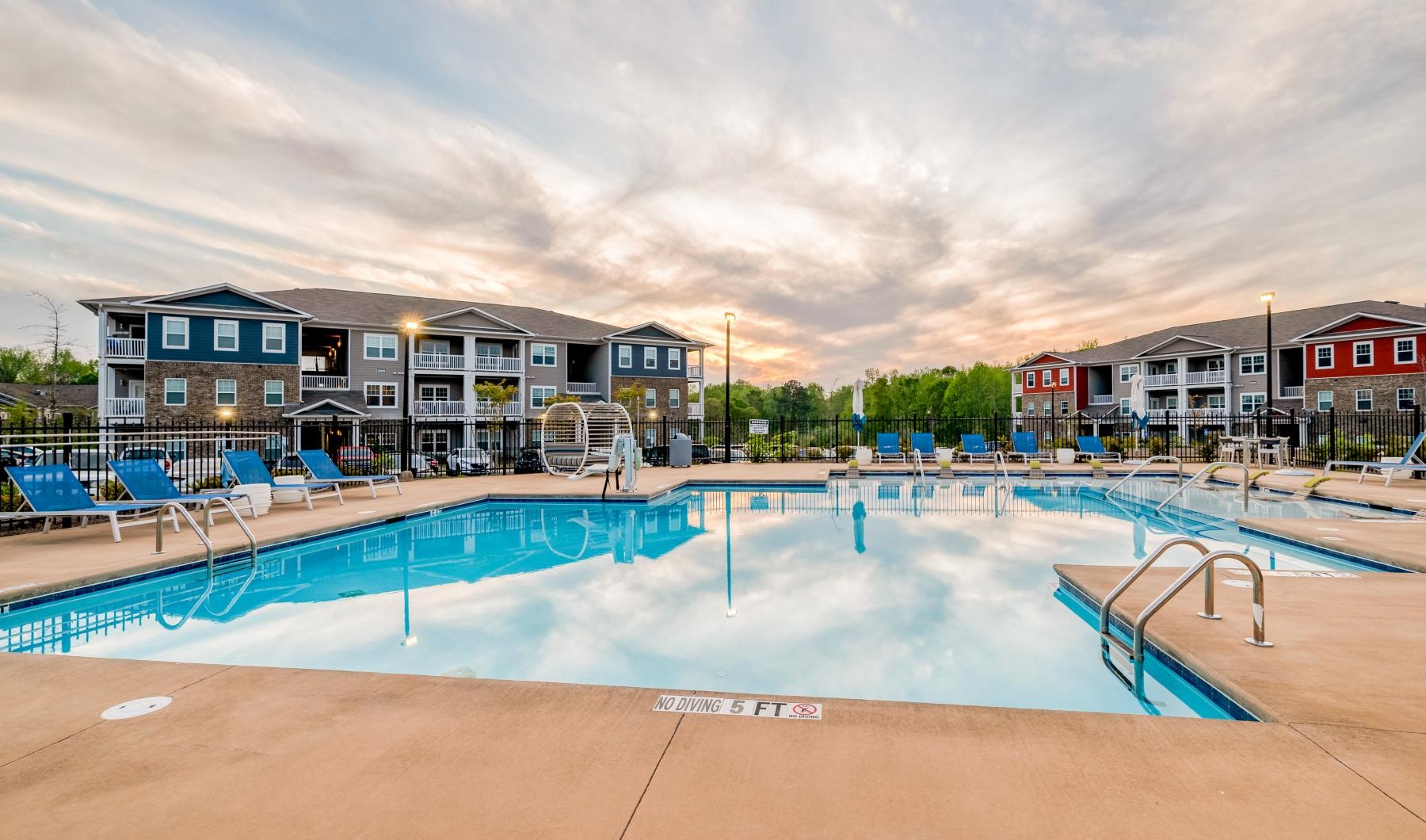 a swimming pool with chairs around it