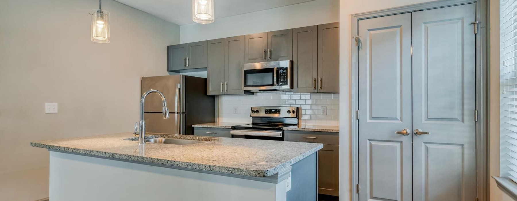 a kitchen with a marble island
